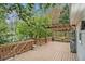 Spacious wooden deck with pergola, ideal for outdoor relaxation and entertainment in a wooded setting at 4272 Glenlake Nw Dr, Kennesaw, GA 30144