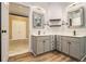 Bathroom with double vanities, modern fixtures, and a doorway leading to a carpeted bedroom at 4272 Glenlake Nw Dr, Kennesaw, GA 30144