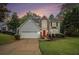Charming two-story home with a red front door, gray siding, brick accent, a manicured lawn, and a two-car garage at 4272 Glenlake Nw Dr, Kennesaw, GA 30144