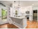 Modern kitchen featuring granite countertops, white cabinets, stainless steel appliances, and hardwood floors at 4272 Glenlake Nw Dr, Kennesaw, GA 30144