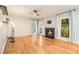 Bright living room with hardwood floors, a modern fireplace, plenty of natural light, and a ceiling fan at 4272 Glenlake Nw Dr, Kennesaw, GA 30144