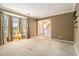 Comfortable living room with natural light, neutral carpet, and entryway at 4272 Glenlake Nw Dr, Kennesaw, GA 30144