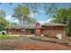 Brick home backyard featuring a patio with seating and landscaping at 851 Rockbridge Sw Rd, Lilburn, GA 30047