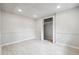 Well-lit basement featuring tile flooring, a large closet, and neutral walls at 851 Rockbridge Sw Rd, Lilburn, GA 30047