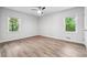Bright bedroom features beautiful wood-look floors and natural light from two windows at 851 Rockbridge Sw Rd, Lilburn, GA 30047