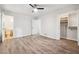 Spacious bedroom with wood-look floors, ceiling fan, and closet with shelves at 851 Rockbridge Sw Rd, Lilburn, GA 30047
