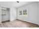 Bedroom boasts wood-look floors, a closet, and a bright window with a view at 851 Rockbridge Sw Rd, Lilburn, GA 30047