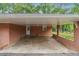 Attached brick carport offers protected parking with convenient access to the home's entrance at 851 Rockbridge Sw Rd, Lilburn, GA 30047