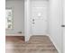 Bright entryway showcasing modern flooring and a freshly painted front door, creating a welcoming atmosphere at 851 Rockbridge Sw Rd, Lilburn, GA 30047