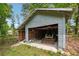 Rustic garage showing machinery and tools, with an open garage door at 851 Rockbridge Sw Rd, Lilburn, GA 30047