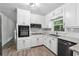 Bright kitchen features white cabinetry, stainless steel appliances, and stone countertops at 851 Rockbridge Sw Rd, Lilburn, GA 30047