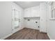 Laundry room with storage cabinets and exterior door at 851 Rockbridge Sw Rd, Lilburn, GA 30047