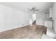 Spacious living room with wood-burning fireplace and ceiling fan at 851 Rockbridge Sw Rd, Lilburn, GA 30047