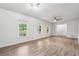 Large living room featuring stylish floors, fresh paint, recessed lighting, and ample natural light at 851 Rockbridge Sw Rd, Lilburn, GA 30047