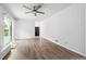 Spacious living room with wood-burning fireplace and sliding glass doors at 851 Rockbridge Sw Rd, Lilburn, GA 30047