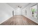 Spacious living room with wood floors, freshly painted walls, and ample natural light from large windows at 851 Rockbridge Sw Rd, Lilburn, GA 30047