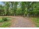 Large wooded property showing a natural setting with mature trees at 851 Rockbridge Sw Rd, Lilburn, GA 30047
