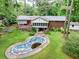 Aerial view of home with in-ground pool, deck, and many trees at 881 Rockbridge Sw Rd, Lilburn, GA 30047