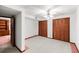 Spacious basement with white walls and carpet, wood trim, and closet at 881 Rockbridge Sw Rd, Lilburn, GA 30047