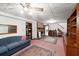 Spacious finished basement with a fireplace, built-in shelving, and comfortable seating on neutral carpeting at 881 Rockbridge Sw Rd, Lilburn, GA 30047