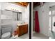 Basement bathroom with shower, vanity, and exposed pipes, featuring unfinished ceiling at 881 Rockbridge Sw Rd, Lilburn, GA 30047