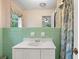 Classic bathroom with a square-tiled vanity, a large mirror, and decorative patterned curtains for privacy at 881 Rockbridge Sw Rd, Lilburn, GA 30047