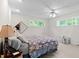 Bedroom with carpeted floors, two windows, a ceiling fan, and neutral walls at 881 Rockbridge Sw Rd, Lilburn, GA 30047