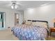 Bright bedroom featuring carpeted floors, a ceiling fan and access to bathroom at 881 Rockbridge Sw Rd, Lilburn, GA 30047