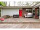 Wooden deck with railings, grill, chair and red door leading to the backyard at 881 Rockbridge Sw Rd, Lilburn, GA 30047
