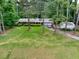 Charming single-story home featuring a well-manicured lawn and mature trees at 881 Rockbridge Sw Rd, Lilburn, GA 30047
