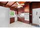 Functional kitchen showcasing wood ceiling, white appliances and wood cabinets at 881 Rockbridge Sw Rd, Lilburn, GA 30047