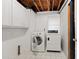 A bright laundry room equipped with a washing machine and dryer at 881 Rockbridge Sw Rd, Lilburn, GA 30047
