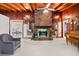 Bright living room featuring brick fireplace, wood paneled walls and access to dining room at 881 Rockbridge Sw Rd, Lilburn, GA 30047