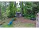 Backyard shed with blue chairs overlooking trees at 881 Rockbridge Sw Rd, Lilburn, GA 30047