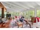 Inviting sunroom with lots of natural light and wooded views at 881 Rockbridge Sw Rd, Lilburn, GA 30047