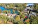 Expansive aerial view of a lakeside home surrounded by colorful fall foliage and docks, plus inset of home's front elevation at 10005 Lakeview Pkwy, Villa Rica, GA 30180