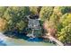 Aerial view of the property, featuring a private dock, spacious backyard, and lake access at 10005 Lakeview Pkwy, Villa Rica, GA 30180
