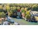 Aerial view showcasing the home's lakefront location, private dock, and surrounding greenery at 10005 Lakeview Pkwy, Villa Rica, GA 30180