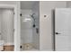 Bathroom featuring a tiled shower, stone floor, and glass door at 10005 Lakeview Pkwy, Villa Rica, GA 30180