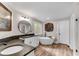 Bright bathroom with a modern tub, vanity, and a window for natural light at 10005 Lakeview Pkwy, Villa Rica, GA 30180