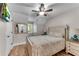 Cozy bedroom featuring wood flooring, a patterned bedspread, and a ceiling fan at 10005 Lakeview Pkwy, Villa Rica, GA 30180