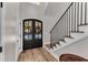 Inviting entryway features beautiful wood flooring, stairs, and French doors adorned with wreaths at 10005 Lakeview Pkwy, Villa Rica, GA 30180