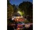 Inviting lake house featuring a large deck and a private boat dock with string lights at 10005 Lakeview Pkwy, Villa Rica, GA 30180