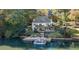 Scenic waterfront backyard with a private dock, boat, and multi-level deck perfect for entertaining and enjoying lake life at 10005 Lakeview Pkwy, Villa Rica, GA 30180