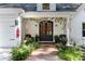 Elegant entryway featuring a decorative front door, manicured landscaping, and charming details, exuding a welcoming ambiance at 10005 Lakeview Pkwy, Villa Rica, GA 30180