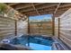 Private outdoor hot tub with a wooden enclosure for ultimate relaxation and privacy at 10005 Lakeview Pkwy, Villa Rica, GA 30180