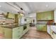 Gourmet kitchen with green cabinets, an island, and modern appliances for culinary enthusiasts at 10005 Lakeview Pkwy, Villa Rica, GA 30180