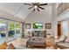 Bright living room with soaring ceilings, fan, deck access, and comfortable seating at 10005 Lakeview Pkwy, Villa Rica, GA 30180