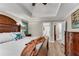 The main bedroom features a wooden bed frame, neutral walls, wood floors, and ensuite access at 10005 Lakeview Pkwy, Villa Rica, GA 30180