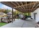 Covered patio featuring an exposed wood beam ceiling, concrete flooring, and views of the lake at 10005 Lakeview Pkwy, Villa Rica, GA 30180